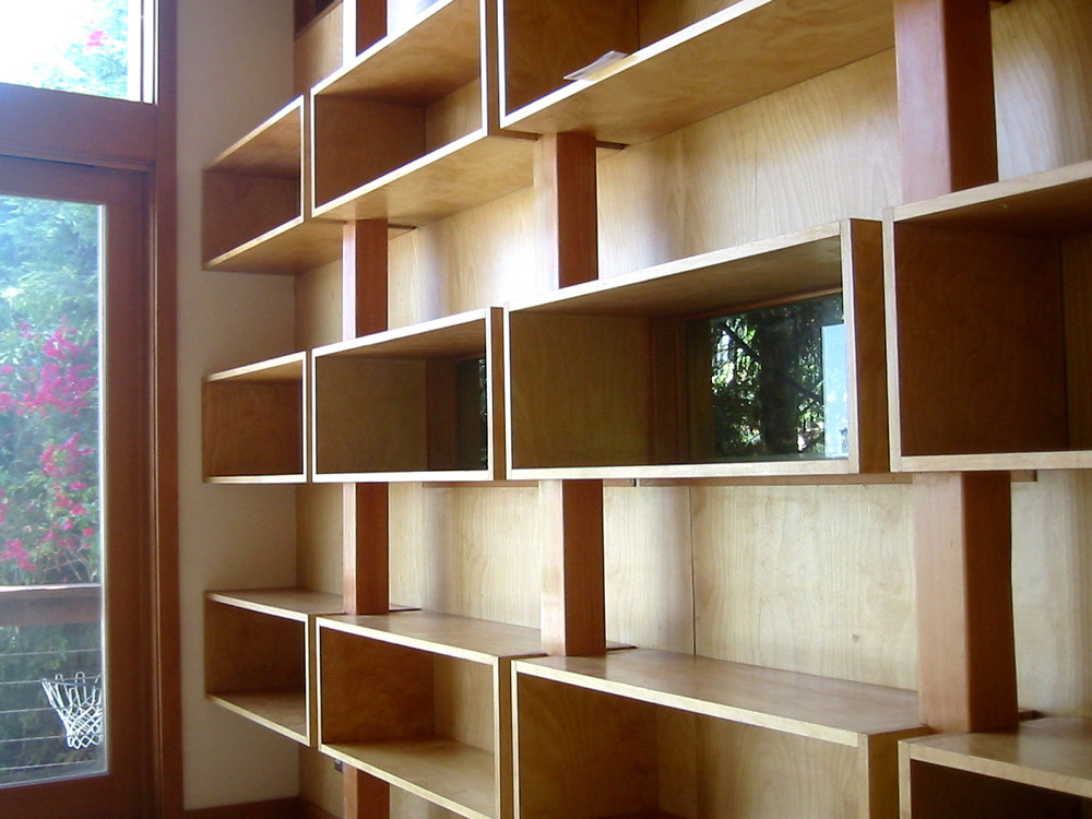 Custom built-in wood shelving beside a window